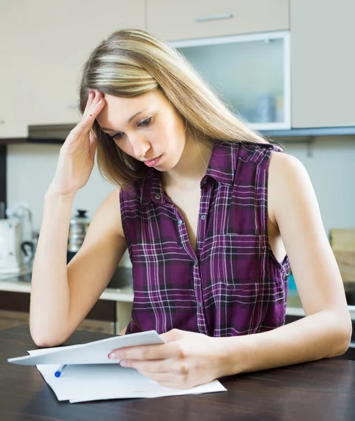 Serious woman with documents in kitchen — Stock Photo, Image