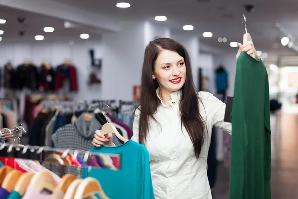 Happy female buyer with sweaters — Stock Photo, Image