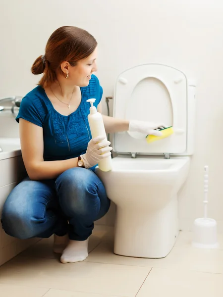 Mulher limpeza vaso sanitário com esponja — Fotografia de Stock