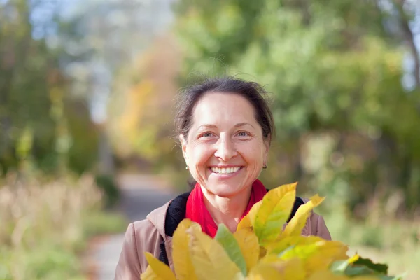 Happy mature woman  in autumn — Stock Photo, Image