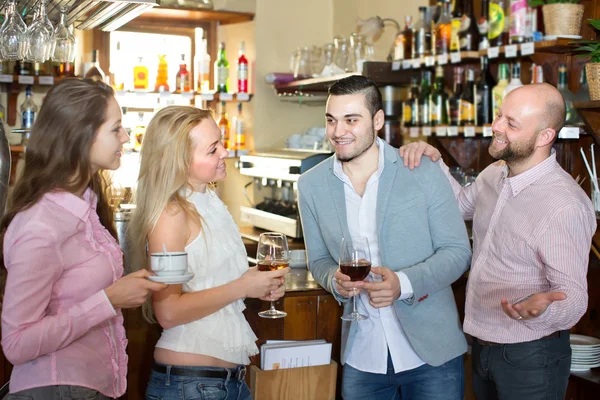 Young happy adults at bar — Stock Photo, Image