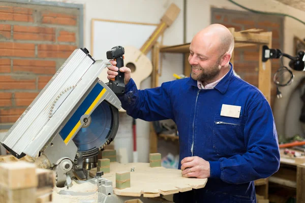 Professional carpenter using power-saw — Stock Photo, Image