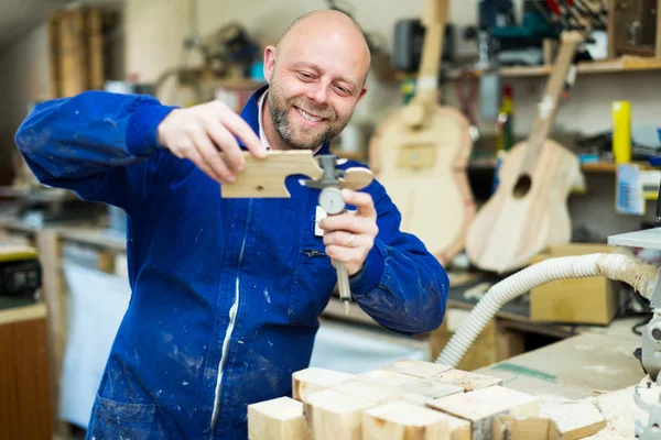 Craftsman working with unfinished guitar — Stock Photo, Image