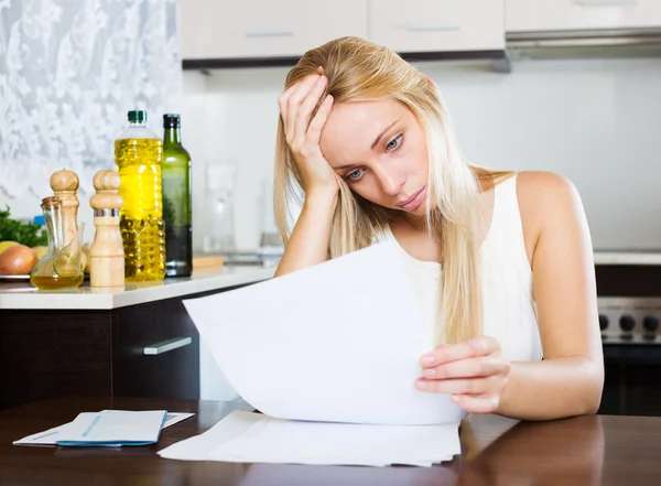 Serious woman staring  documents — Stock Photo, Image
