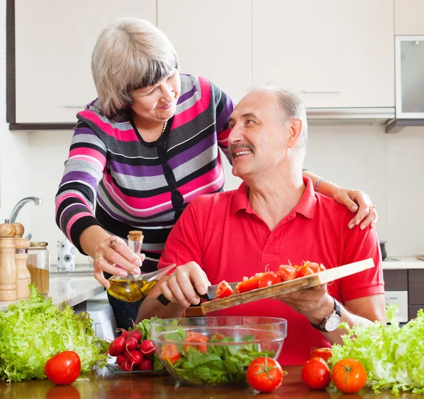 Smiling mature couple cooking  together — Stock Photo, Image