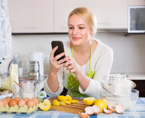 Mädchen mit Smartphone in der Küche — Stockfoto