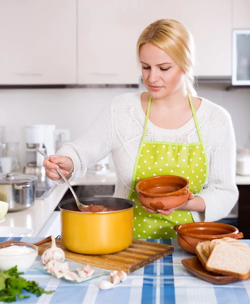 Blonde in apron with meat — Stock Photo, Image