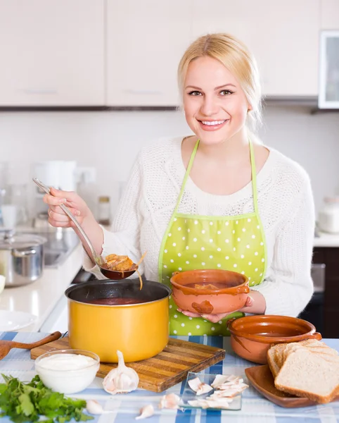 Housewife cooking soup — Stock Photo, Image