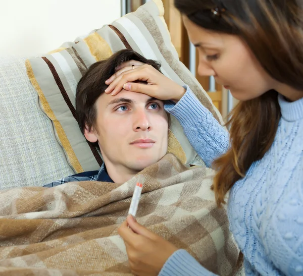 Woman caring for sick guy — Stock Photo, Image