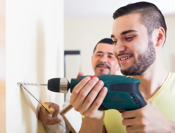 Son and father drilling wall — Stock Photo, Image