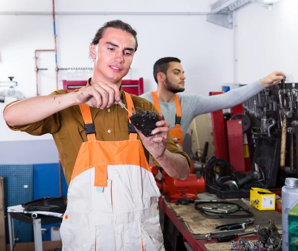 Workers in uniform at workshop — Stock Photo, Image