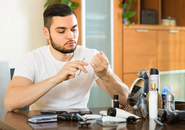 Young guy cutting nails — Stock Photo, Image