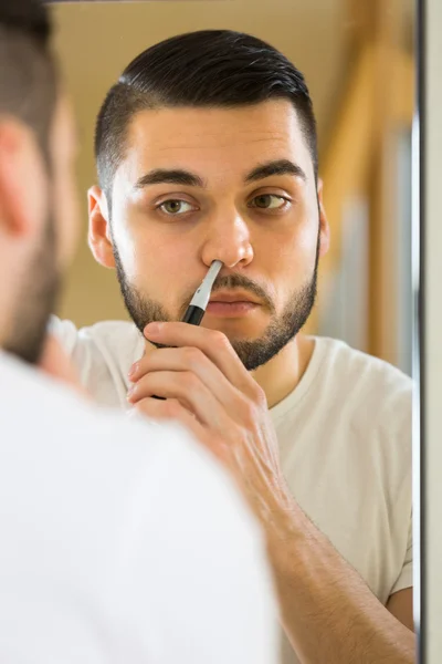 Guy  removing hair in his nose — Stock Photo, Image