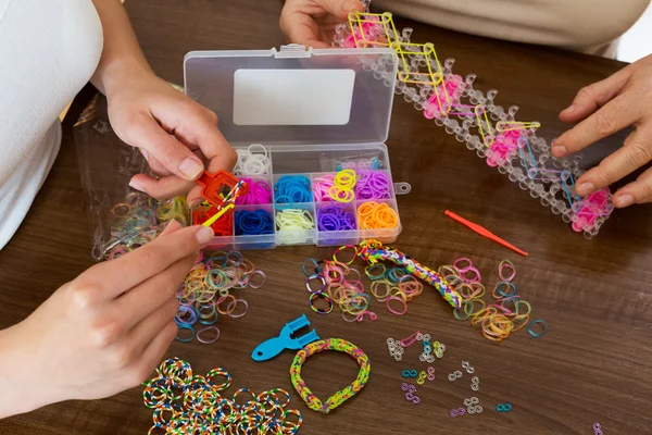 Women making decorative bracelets — Stock Photo, Image