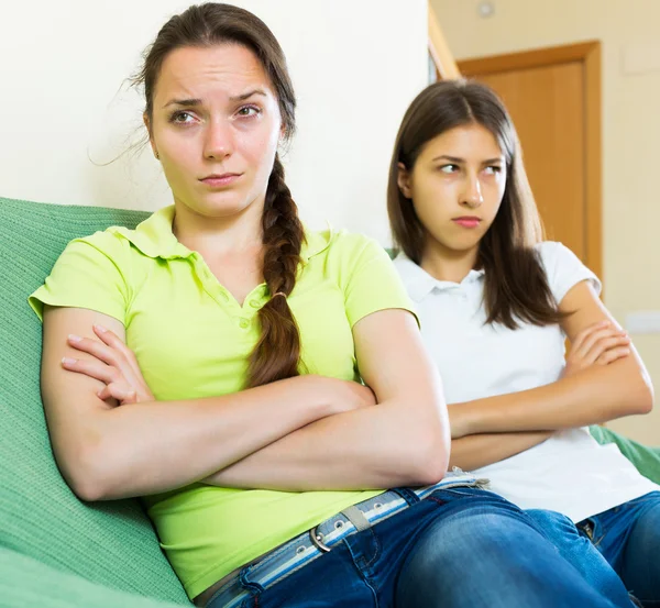 Girls friends sitting and discontent — Stock Photo, Image