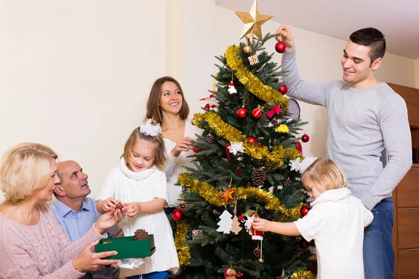 Family with decorated Christmas tree Stock Photo