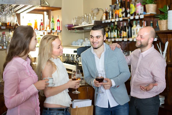 Young happy adults at bar — Stock Photo, Image