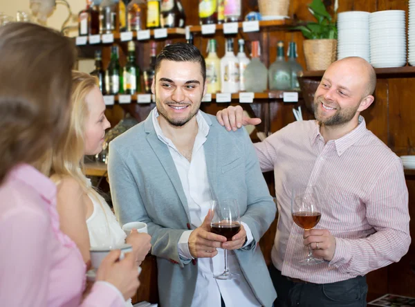 Young happy adults at bar — Stock Photo, Image