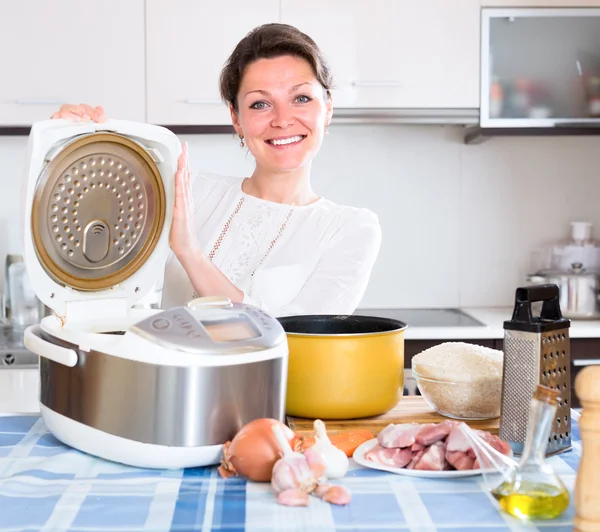 Dona de casa cozinhar arroz no multifogão — Fotografia de Stock