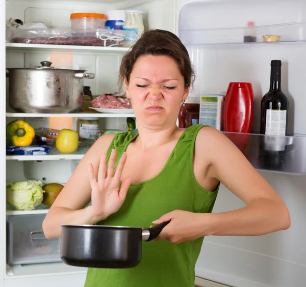 Woman holding nose near refrigerator — Stock Photo, Image