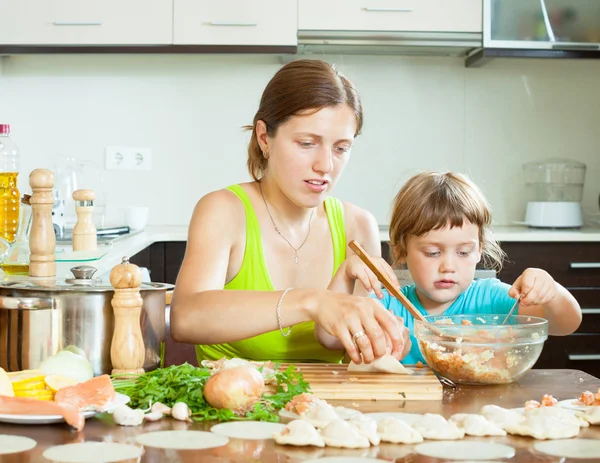 Mamma med sin dotter gör dumplings — Stockfoto