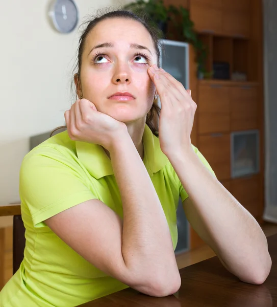 Sad woman sitting at home — Stock Photo, Image