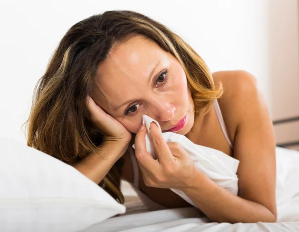 Upset woman laying in bed — Stock Photo, Image