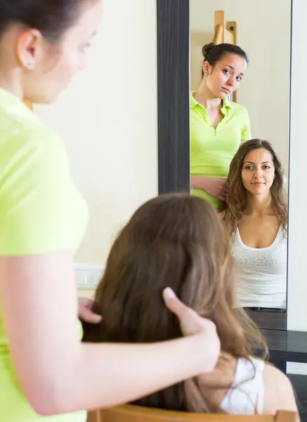 Girl brushing her friend at home — Stock Photo, Image