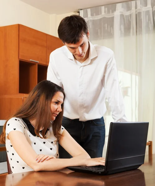 Couple with notebook at home Stock Image