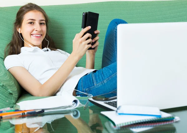 Muchacha joven usando el ordenador portátil en casa — Foto de Stock