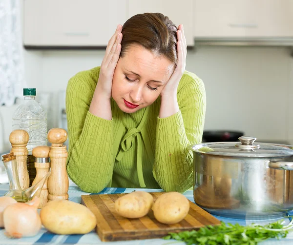 Tired housewife at kitchen — Stock Photo, Image