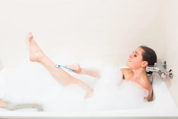 Girl in foam at bathtub — Stock Photo, Image