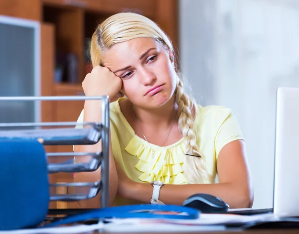 Tired girl sitting at desk — Stock Photo, Image