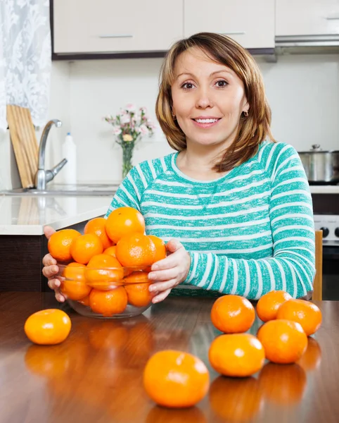 Kvinna med färska mandariner — Stockfoto