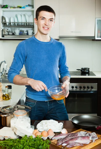 Smiling guy preparing batter — Stock Photo, Image