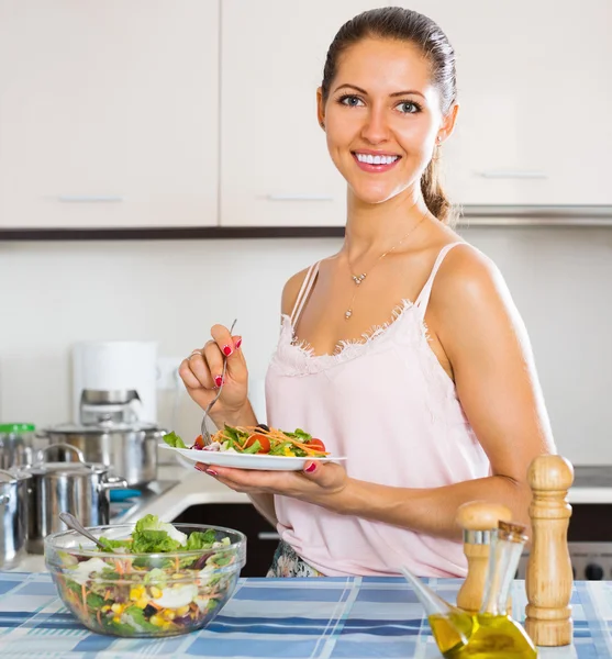 Jonge vrouw eet salade met groenten — Stockfoto