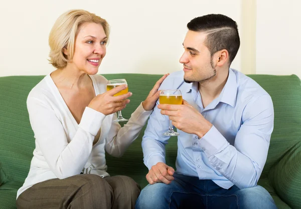 Mature woman with young guy indoors — Stock Photo, Image