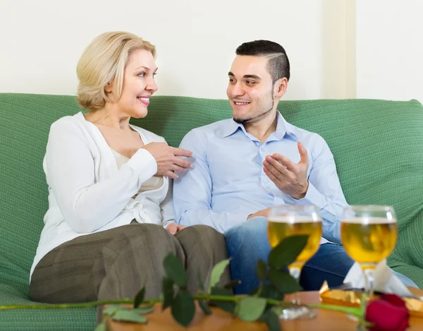 Mature woman with young guy indoors — Stock Photo, Image