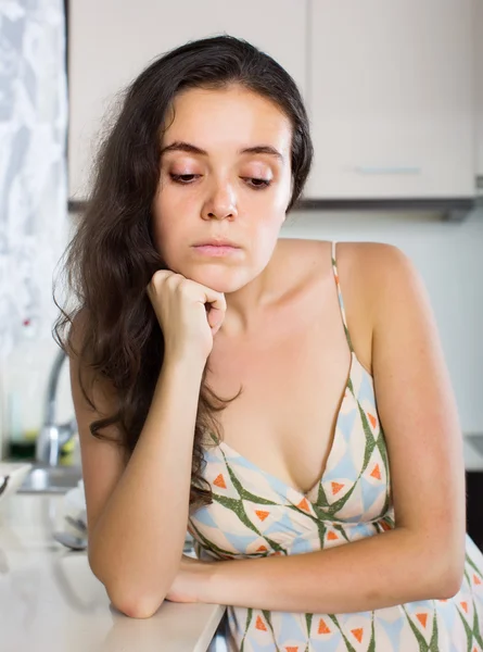Unhappy young woman at kitchen — Stock Photo, Image