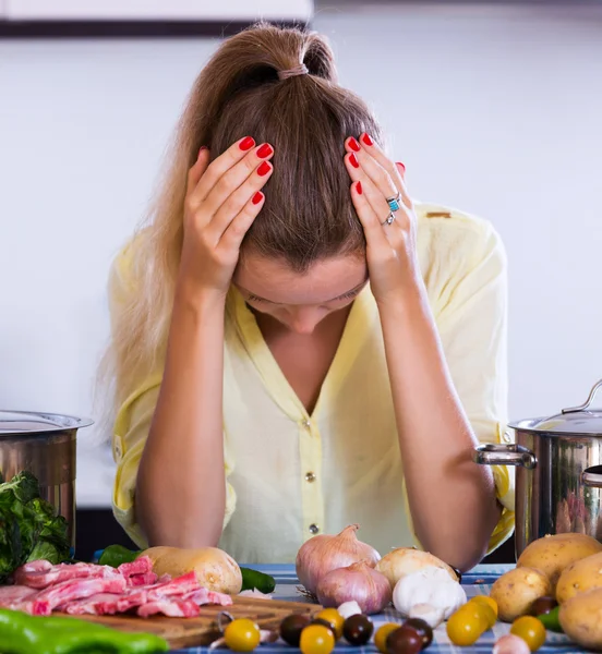 Unhappy girl looking at ingredients — Stock Photo, Image