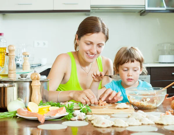 Mother with daughter makes a Fish dumplings — Stock Photo, Image