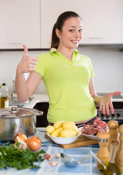 Housewife cooking soup at kitchen — Stock Photo, Image