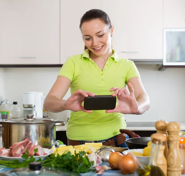 Housewife taking photo at kitchen — Stock Photo, Image