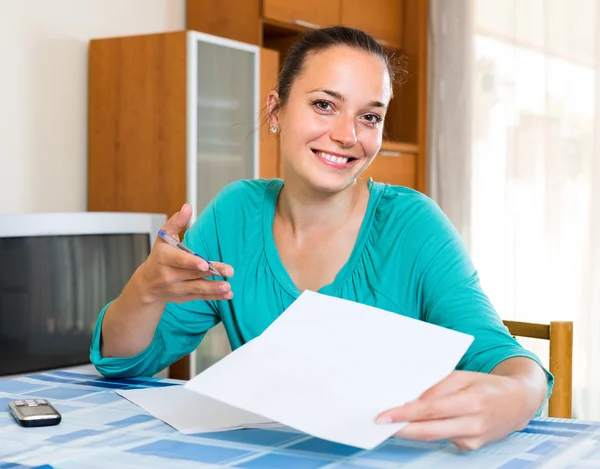 Girl with papers at the table — Stock Photo, Image