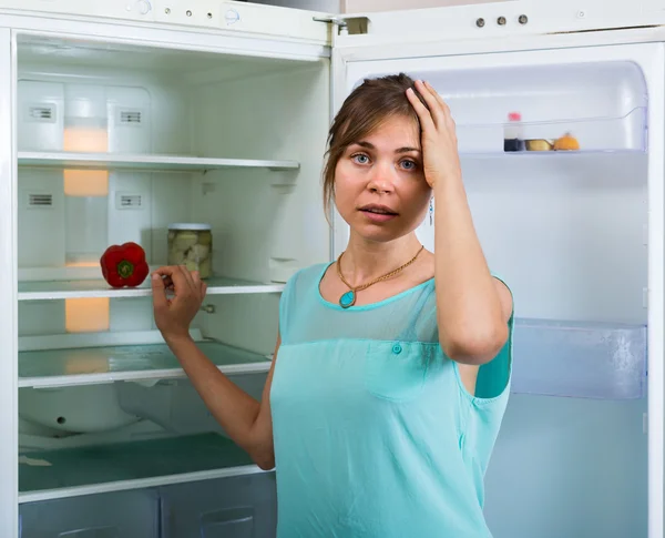 Hungry girl near empty fridge — Stock Photo, Image