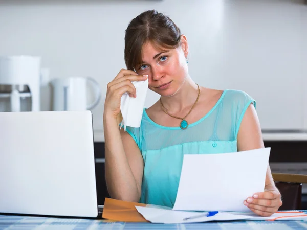 Depressed girl with documents at kitchen — Stock Photo, Image