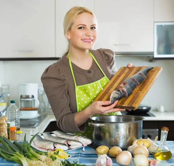 Housewife cooking soup with fish — Stock Photo, Image
