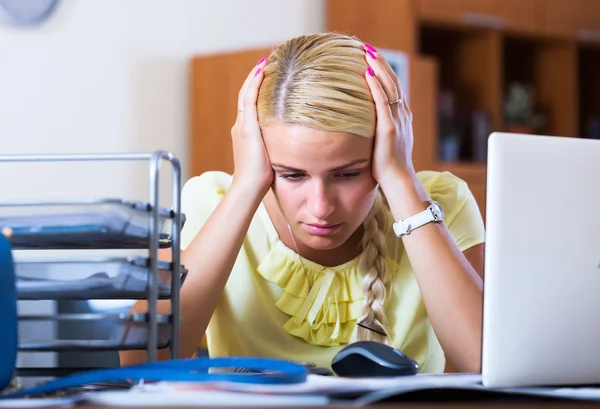 Tired woman sitting at desk — Stock Photo, Image