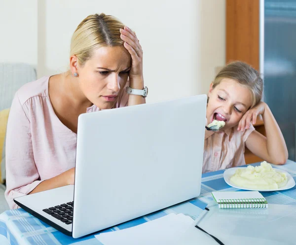 Woman working, daughter asking for attention — Stock Photo, Image