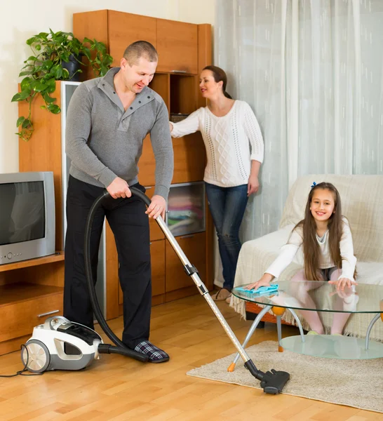 Family of three cleaning at home — Stock Photo, Image